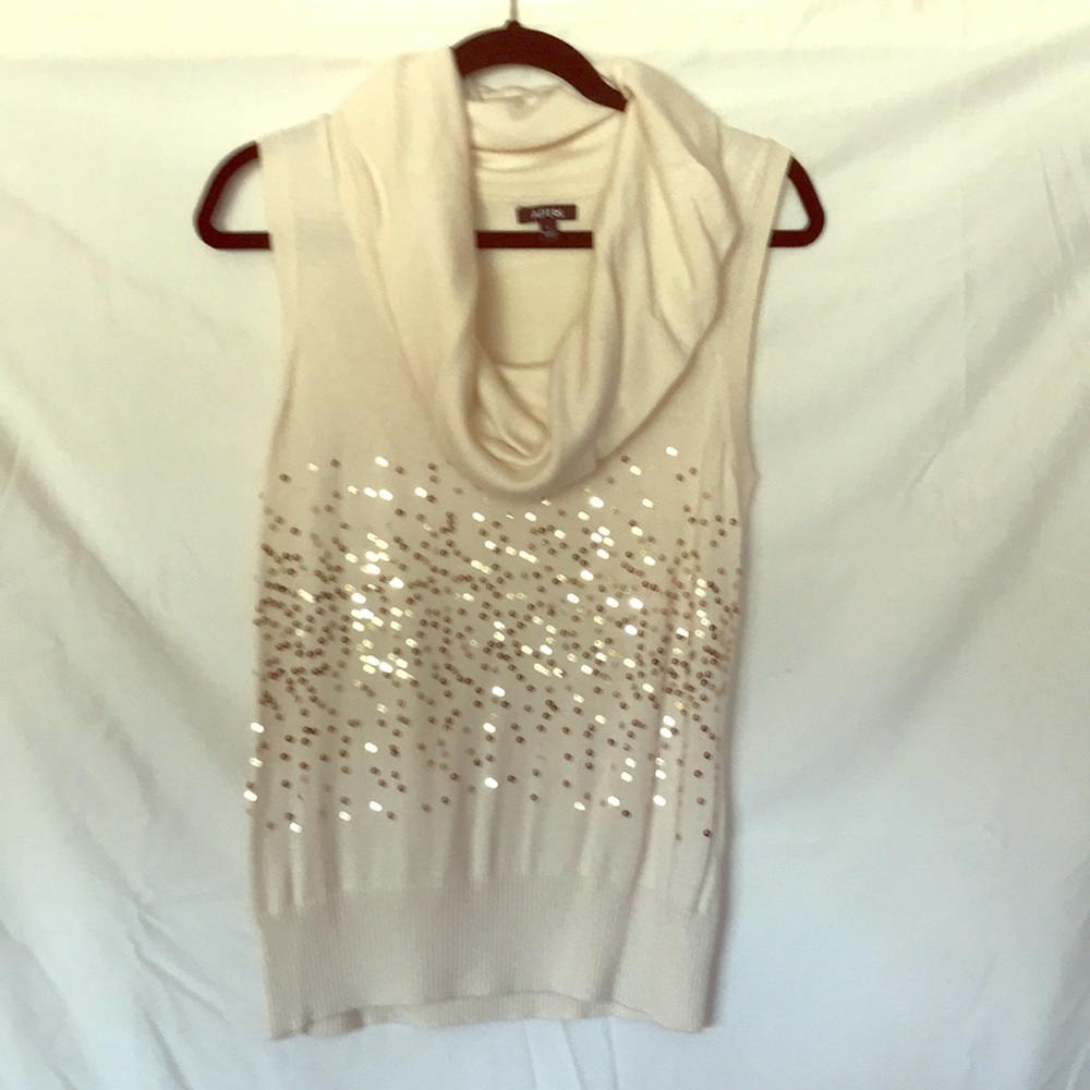 Cream color sleeveless knit top.
